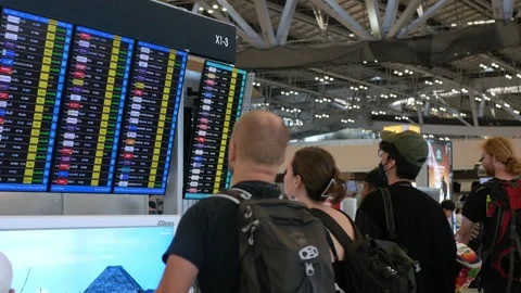 Inside view of the departure terminal with crowded passenger checking infor.. Stock Footage 259465516