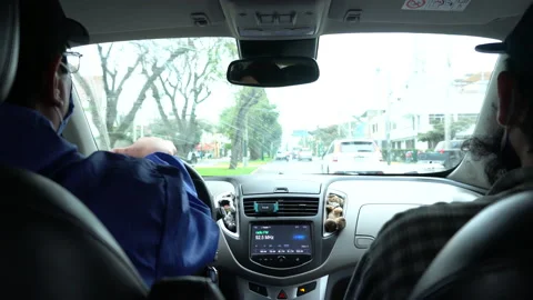 Inside view of a driver driving and a passenger in a car with their masks Vidéo 140318214