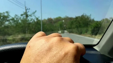 Inside view of Drivers holding steering wheel and driving on highway during day. Stock Footage 336267602
