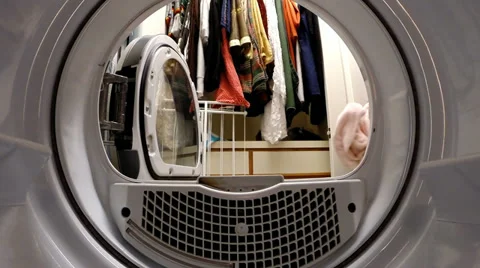 Inside view from dryer of being loaded by a woman, tumbling, and unloaded. Stock Footage 37303583