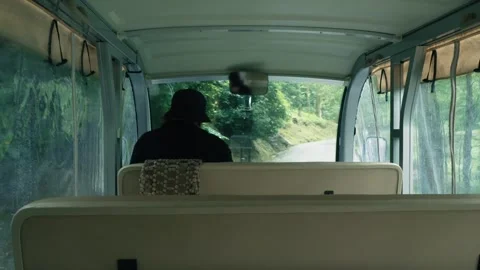 Inside view of electric mini bus during journey through lush park, passenger Stock Footage 274681256