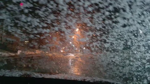 Inside view of front windshield of a driving in blizzard car. Empty night road. Stock Footage 144385136