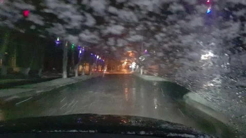 Inside view of front windshield of a driving in blizzard car. Video stock 144733921