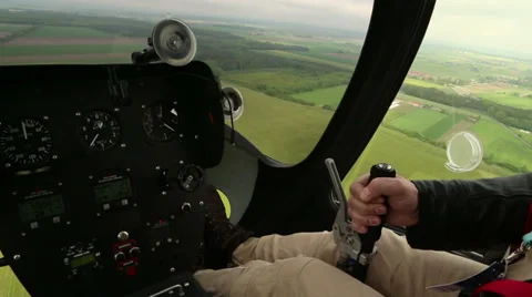 Inside view of gyrocopter pilot's cabin/cockpit during landing on grassy land Stock Footage 38501802