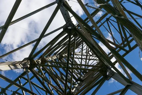 Inside view. high voltage tower construction against blue sky with clouds Foto stock