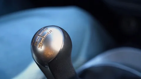 Inside view of lever of a manual gearbox of car сlose up sunny day slow motion  Stock Footage 127790257