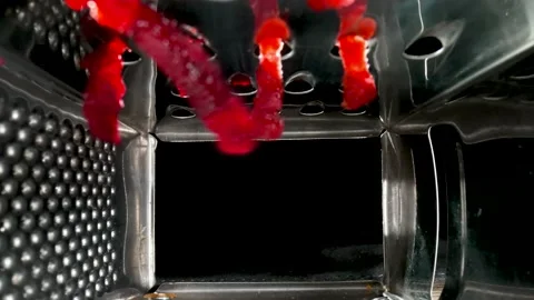 Inside view of metal grater grating red beetroot on black background. Kitchen Stock Footage 184566238