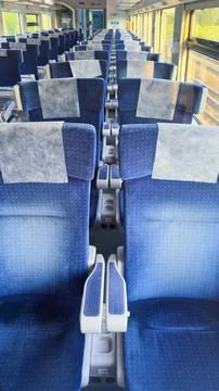 Inside View of a Modern Train Coach Featuring Comfortable Blue Fabric Seats with Stock Photos
