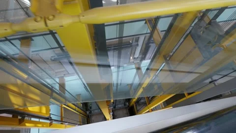 Inside view of a modern wind tunnel structure with glass and yellow beams in  Stock Footage 282472003