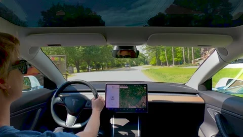 Inside view of a new Tesla Model 3 driving down the road Stock Footage 137180576