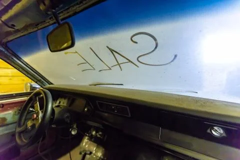 Inside view of old broken car interior with dusty vehicle dashboard, back mirror Stock Photos