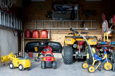 Inside view open door ATV quad bike motorcycle parking messy garage,clutter Stock Photos