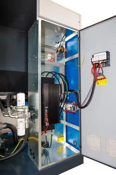 Inside view of an opened electrical control cabinet revealing various compone Stock Photos