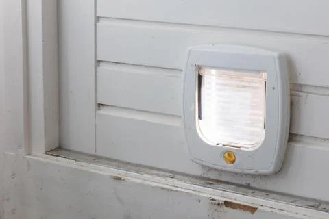 Inside view of a regular white cat flap, flap closed Stock Photos