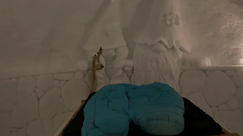 Inside view of snow iglu with bed and beautiful carved art, ice carving Stock Footage 147128117