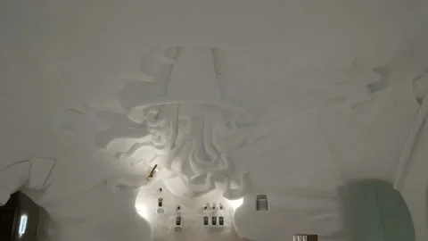 Inside view of snow iglu with bed and beautiful carved art, ice carving Stock Footage 147128142