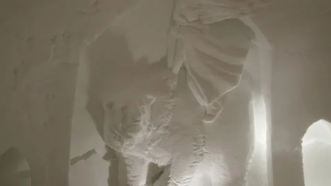 Inside view of snow iglu with bed and beautiful carved art into snow, ice Stock Footage 147128184