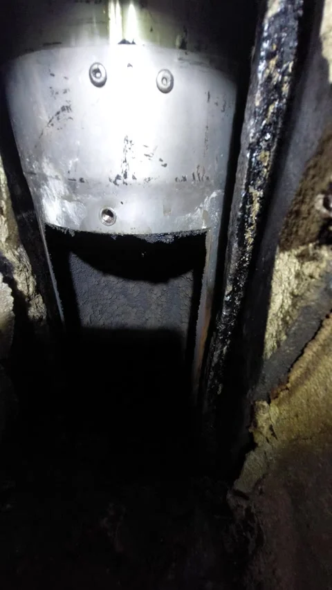 Inside view of a stainless steel chimney flue with soot Stock Footage 333643779