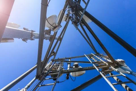 Inside view of telecommunication tower with microwave, radio antennas and cables Stock Photos