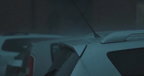 Inside view through the window to the car parking. Raining heavily on the street Видео 120984333