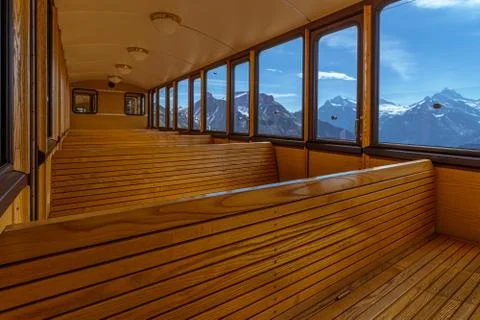 Inside view of a train with mountains in the background Stock Photos