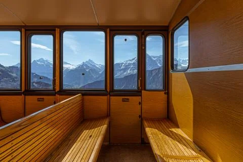 Inside view of a train with mountains in the background Stock Photos