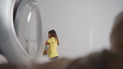 Inside Washer View Of Toddler Dancing With Blue Towel Past Open Door 스톡 동영상 318843900
