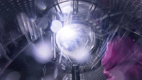 Inside a Washing Machine Drum During Wash Cycle with Spinning Clothes Stock Footage 332908272