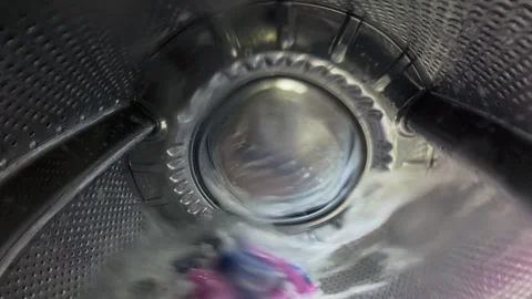 Inside a Washing Machine Drum During Wash Cycle with Spinning Clothes Video stock 332908426