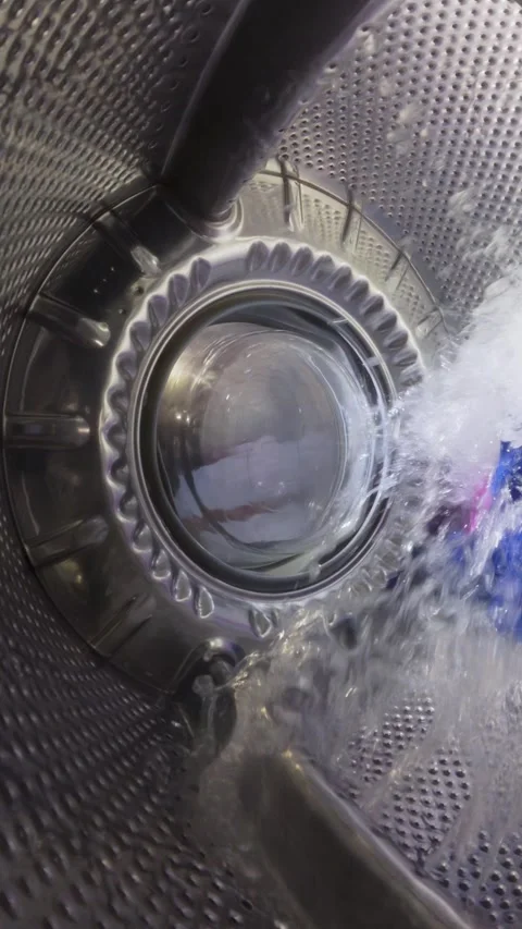 Inside a Washing Machine Drum During Wash Cycle with Spinning Clothes Stock Footage 332908821