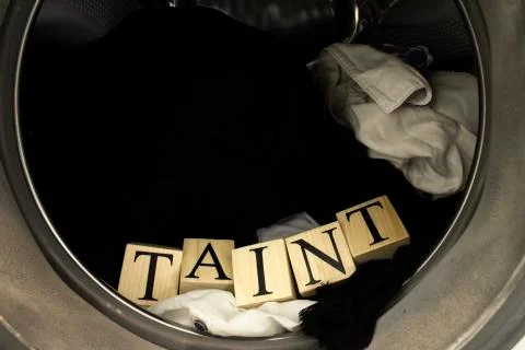 Inside the washing machine. Inside, there is laundry and text from wooden cubes. Stock Photos