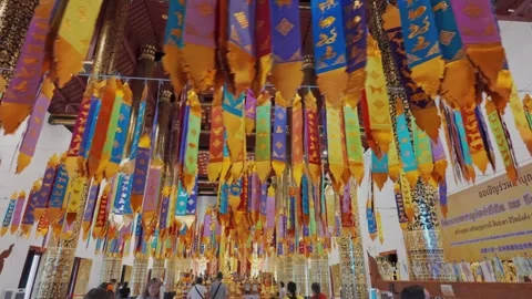 Inside Wat Phra Singh, Chiang Mai, Thailand, with colorful prayer flags Stock Footage 336581620