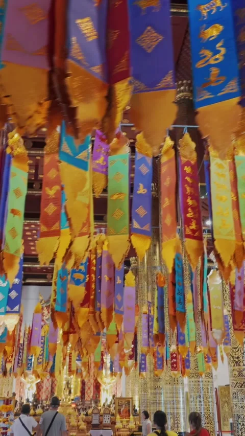 Inside Wat Phra Singh, Chiang Mai, Thailand, with colorful prayer flags Stock Footage 336581848