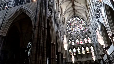 Inside of Westminster Abbey with a big stained glass rosette on top. Stock Footage 235416780