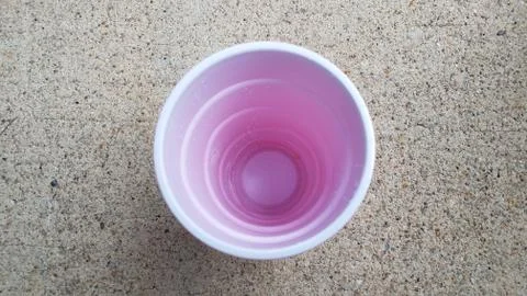 Inside white and red plastic cup on grey cement Stock Photos