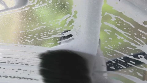Inside of a windshield being scrubbed down at carwash Stock Footage 154062536
