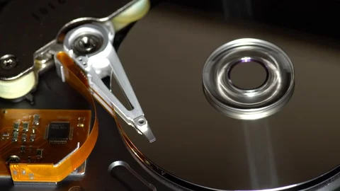 Inside a working computer hard disk drive read write data moving light source Stock Footage 95215710