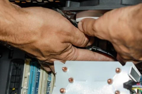 The insides of a computer in the hands of a technician Stock Photos