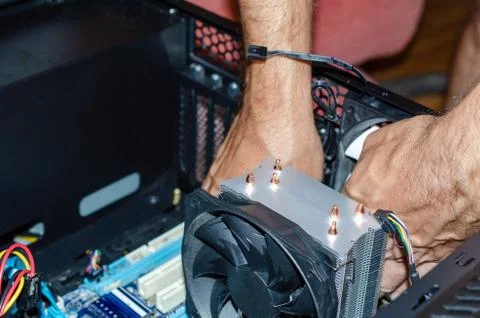 The insides of a computer in the hands of a technician Stock Photos