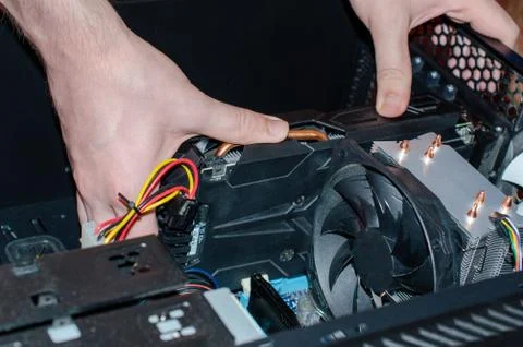 The insides of a computer in the hands of a technician Stock Photos