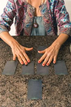 Insightful tarot reader shuffling the cards, creating a moment of suspense .. Stock Photos