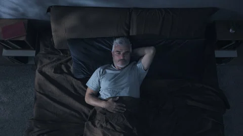 Insomnia problem depression mature man on bed has trouble sleeping Stock Footage 249811161