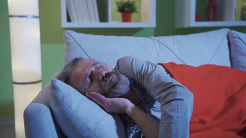Insomnia problem. Tired man disturbed by his thoughts trying to sleep in bed. Stock Footage 230982216