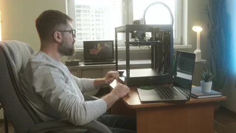 Inspecting 3d printed object in modern start up office Stock Footage 237310471