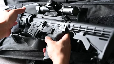 Inspecting an AR 15 rifle with scope Stock Footage 146653359