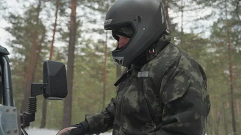 Inspecting ATV in winter forest. Rider conducts safety check in snowy woods Video stock 345145237