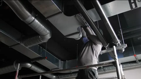 Inspecting construction site worker checks ventilation duct shaft pipe Vídeo Stock 271233969