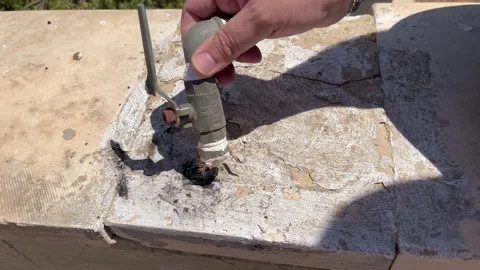 Inspecting a Damaged Old Plumbing Valve and Pipe Stock Footage 345209898