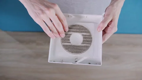 Inspecting Dusty Mesh Filter on Household Exhaust Fan Cover 動画素材 341397912
