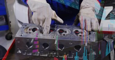 Inspecting engine head, tech in blue-cover red-trim and gloves at red bench with Stock Photos